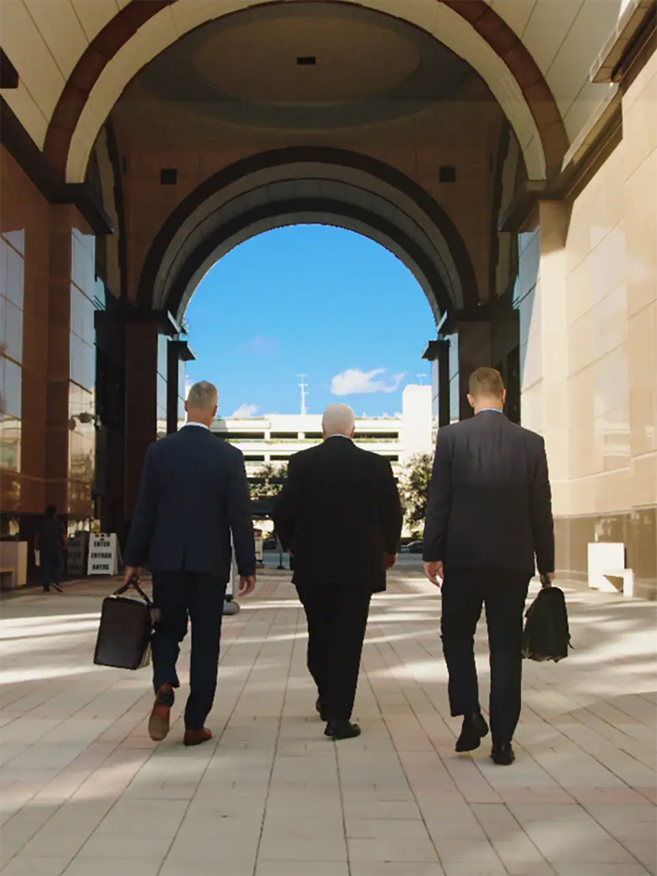 3 men in suits walking to the office