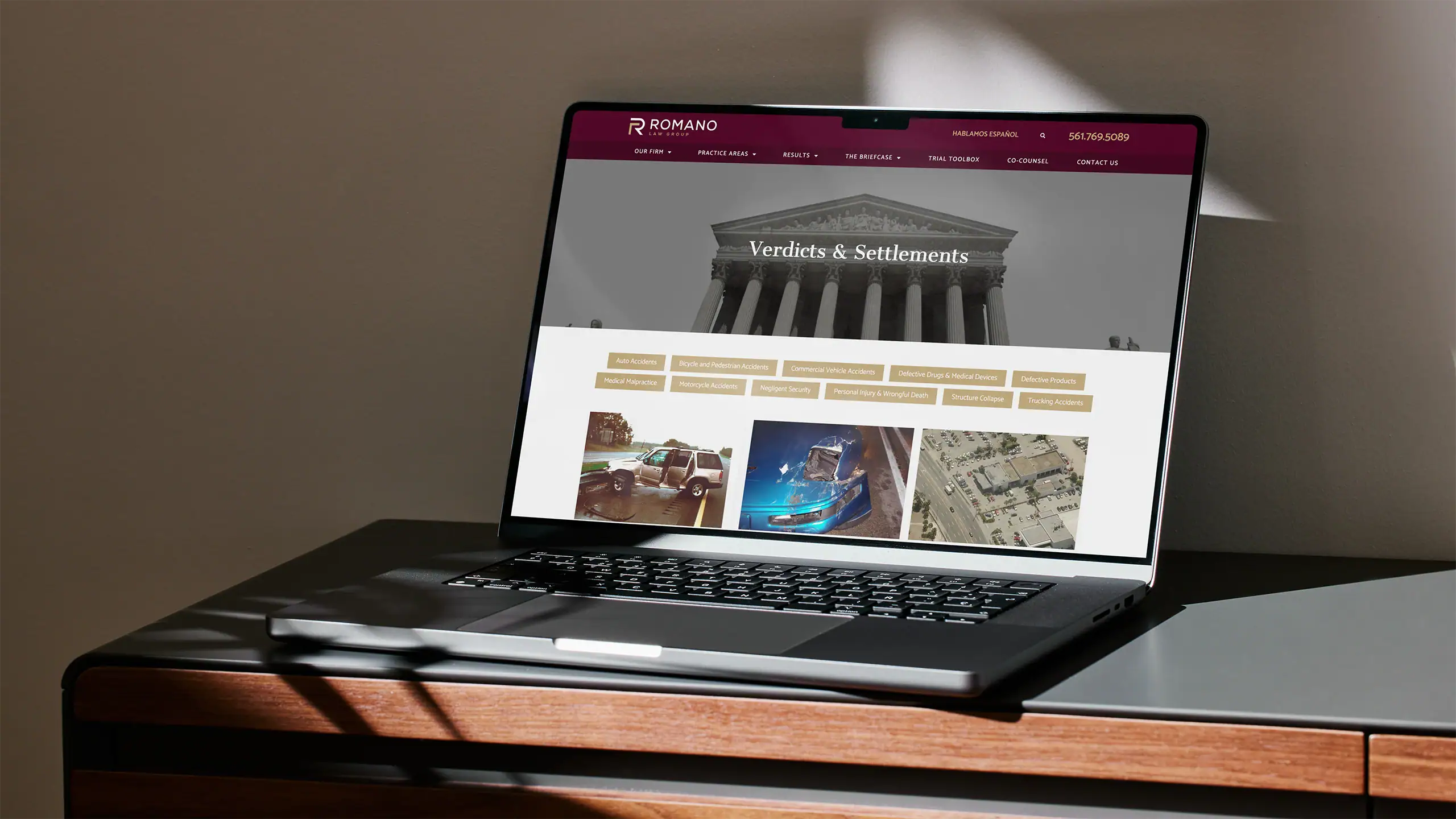 Romano Law Group verdicts and settlements page laptop view