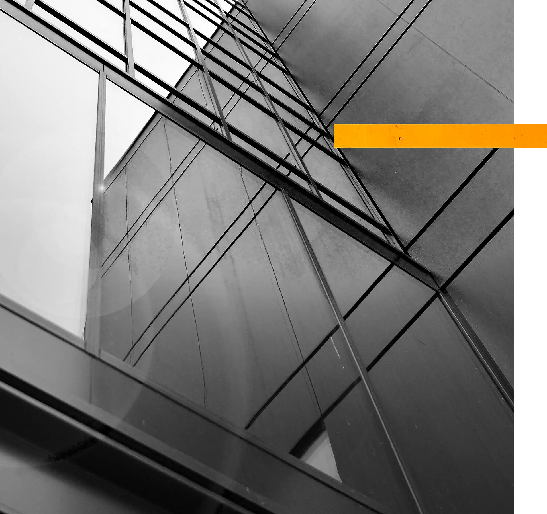 Glass building with geometric reflections and lines in black and white.