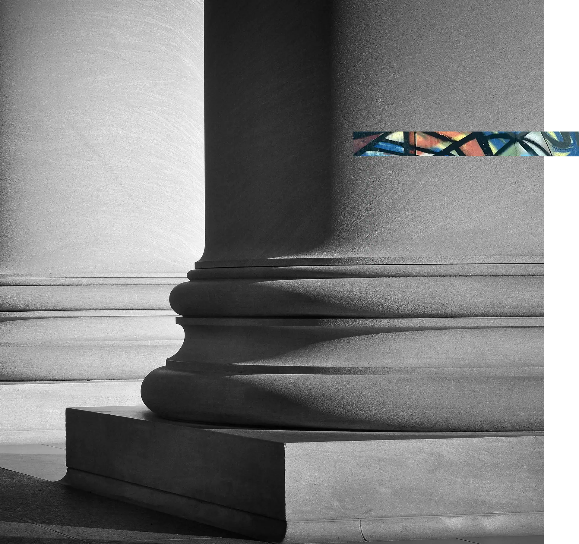 Elegant gray stone column with a vibrant abstract painting on the wall behind.