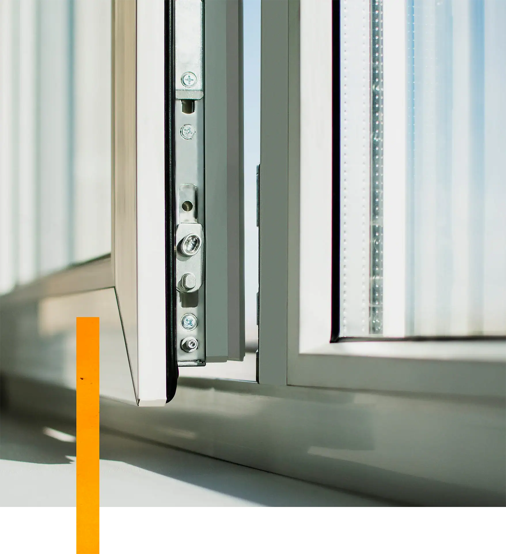 Window frame with metal hardware and glass pane, close-up view.