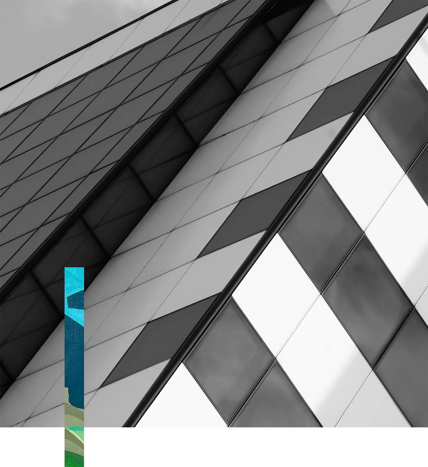 Modern glass building with geometric patterns and reflective surfaces.