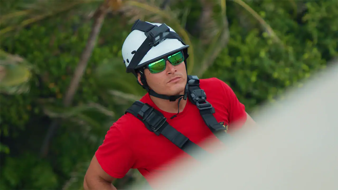 Man with Sunglasses and a Helmet Scaling a building