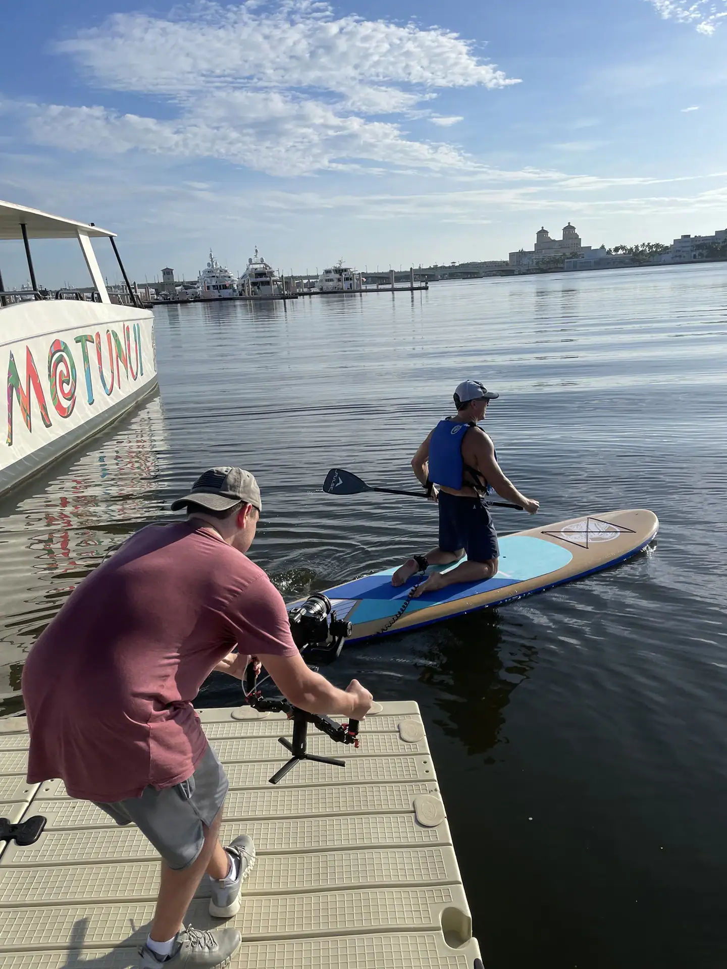 Alex filming man on a paddle board.