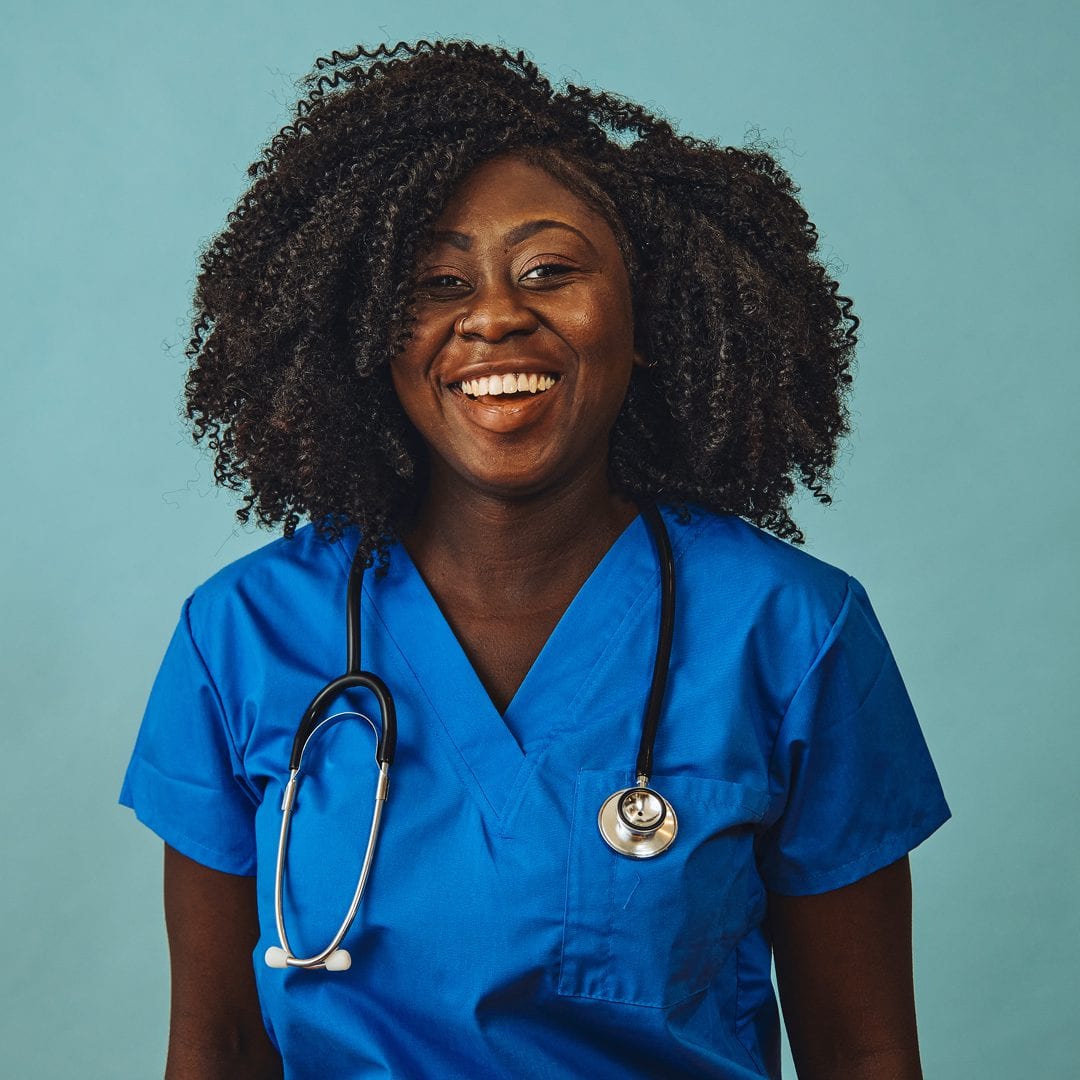 picture of a healthcare worker in blue scrubs and a stethoscope around her neck