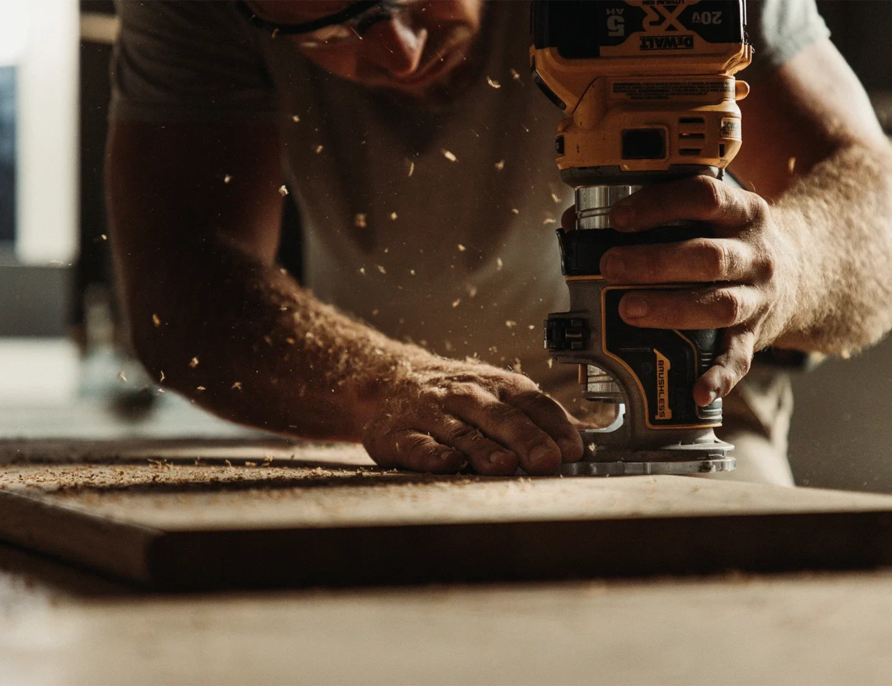 picture of a man using a tool to cut a piece of wood