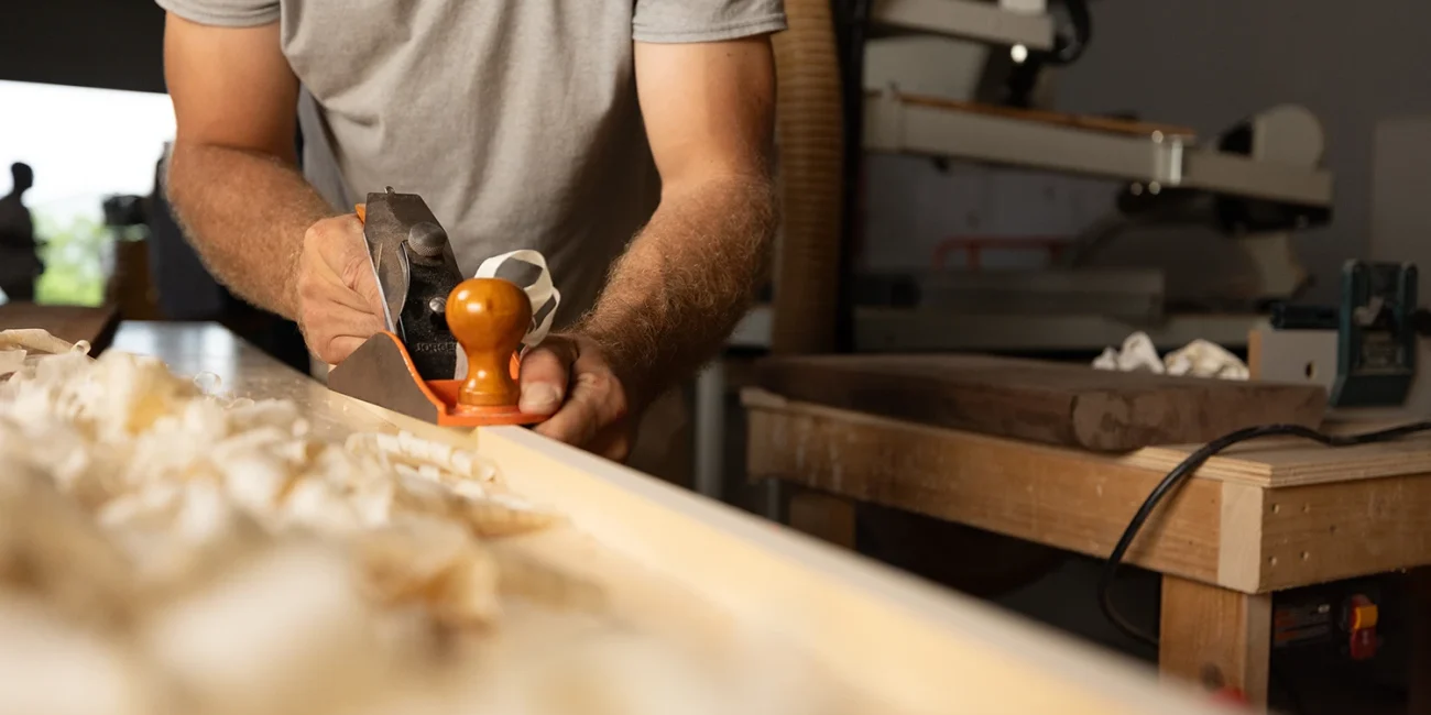 picture of a man shaping wood