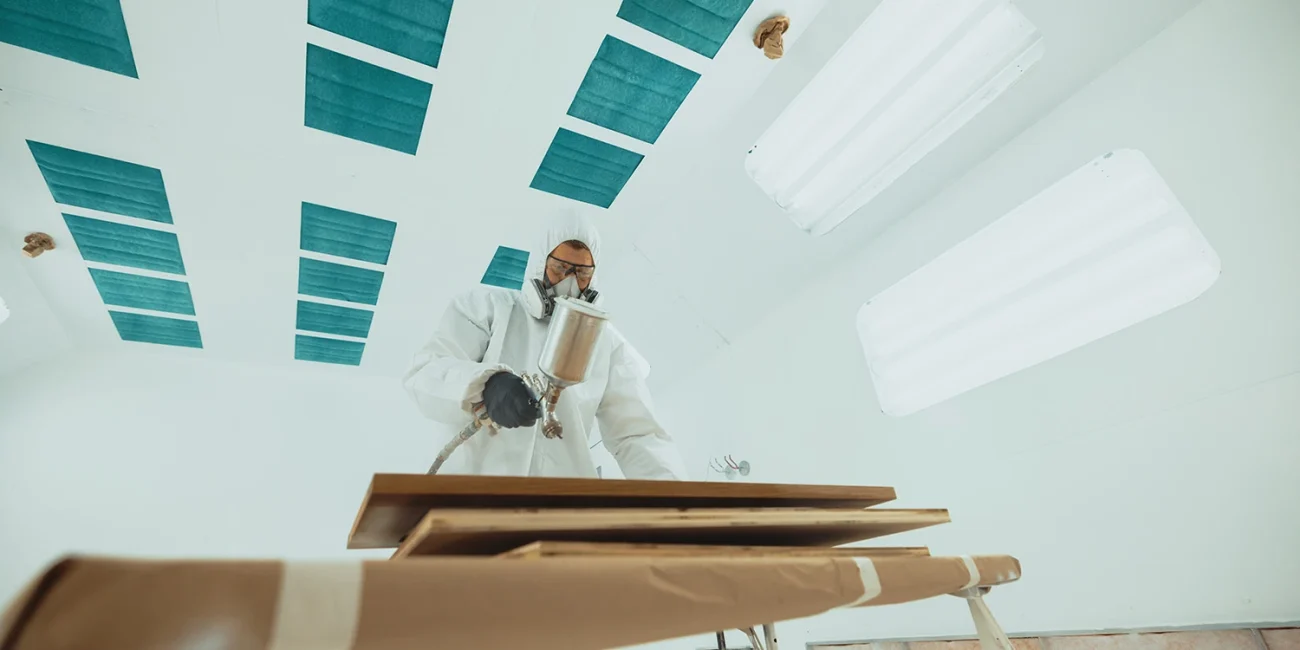 picture of a man staining wood
