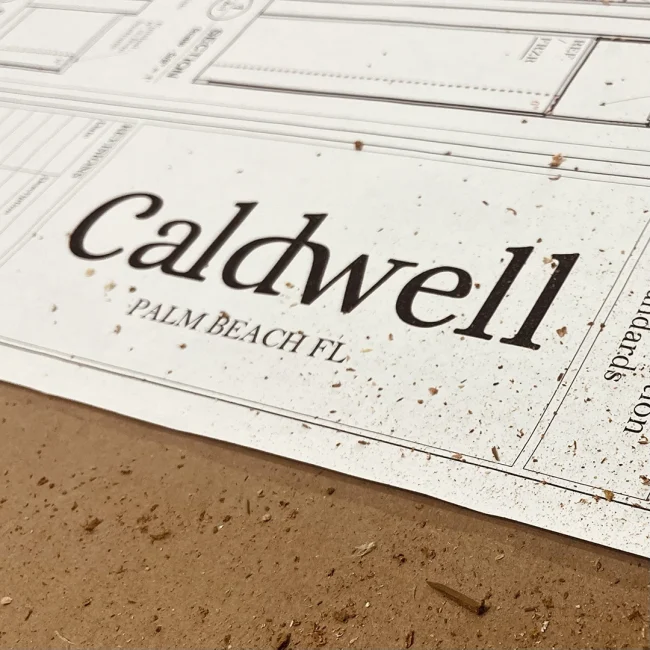 picture of an architectural drawing with the caldwell logo with lite sawdust on it