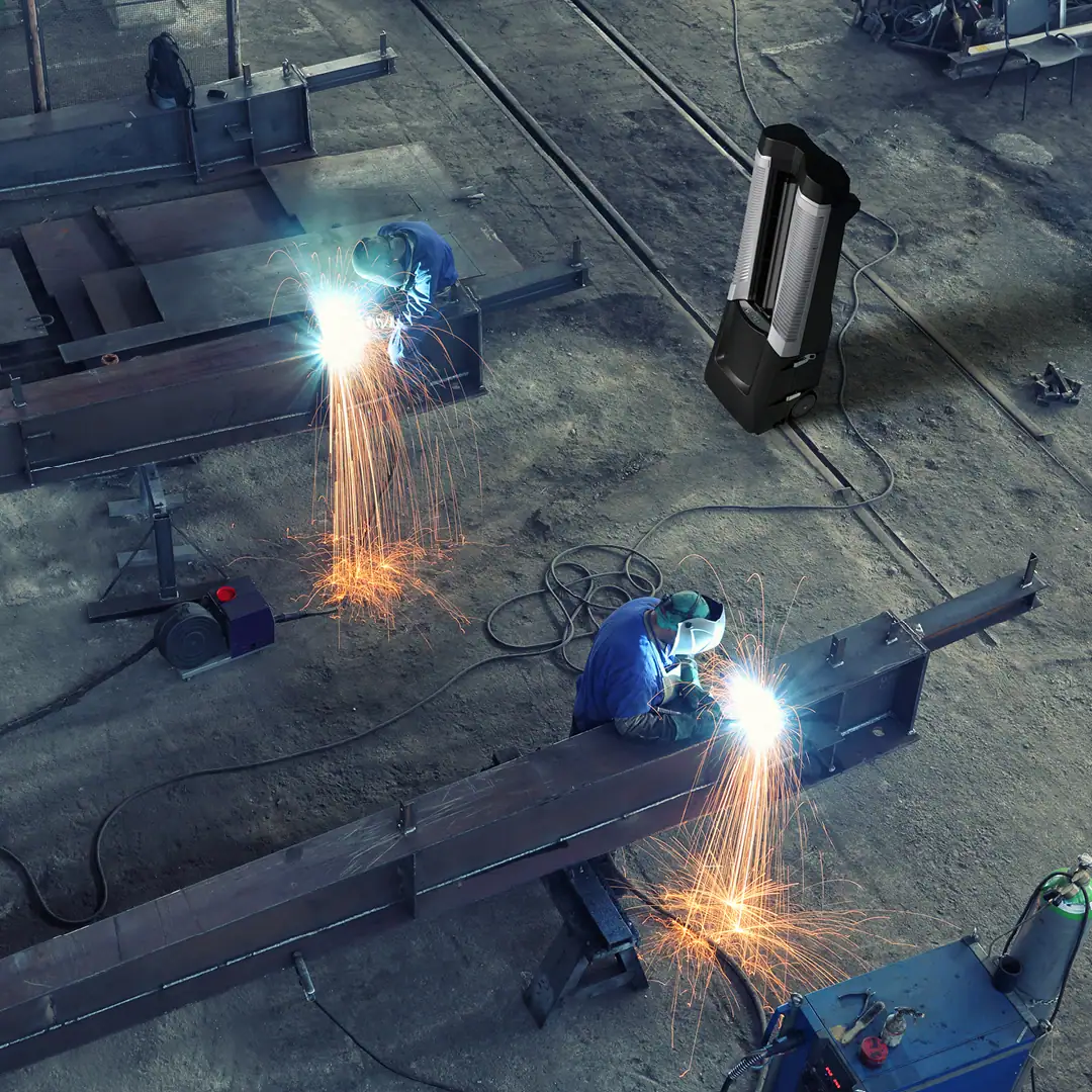 Men working in a factory being cooled by a vector unit