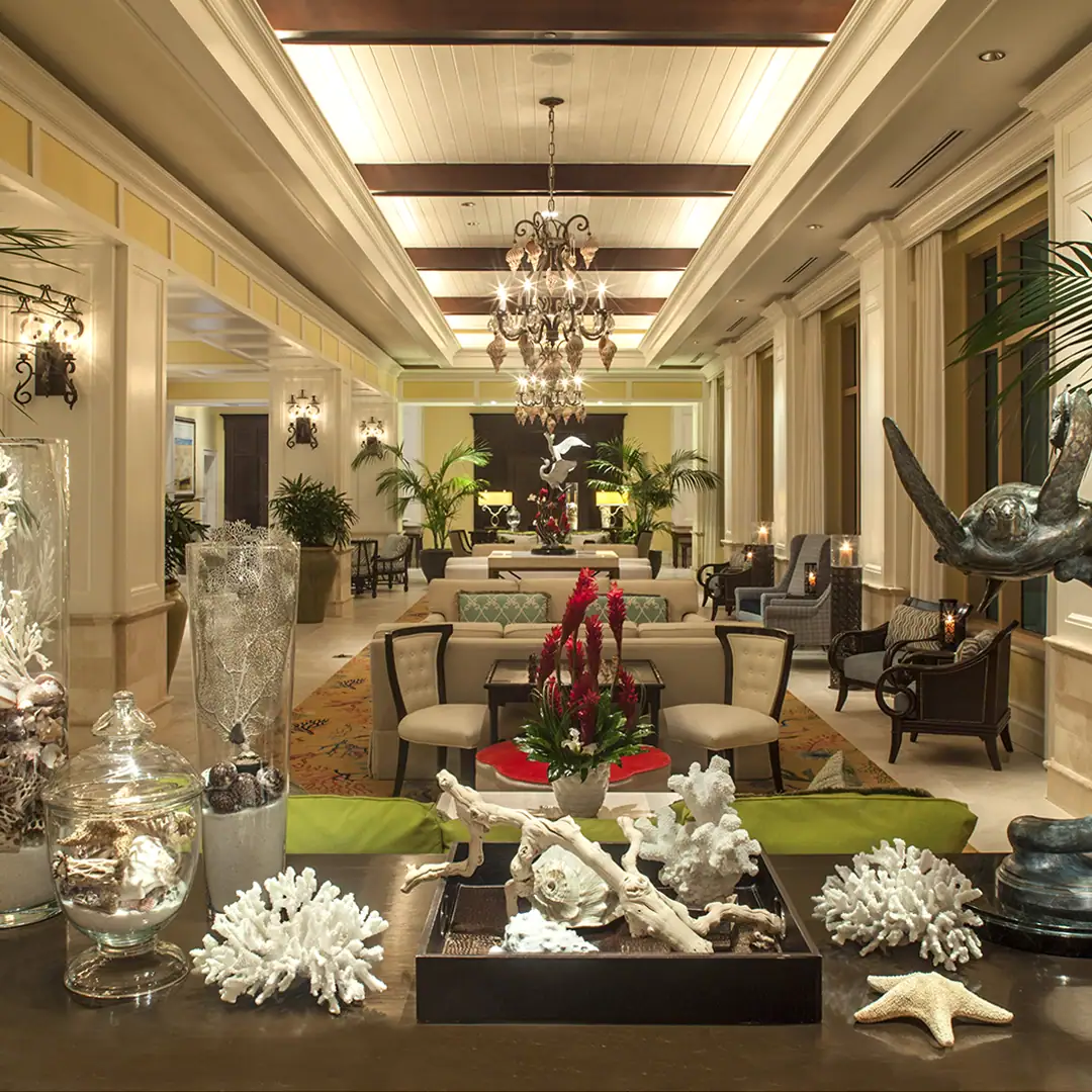 Picture of a well decorated hotel room with furniture and other costal decorations