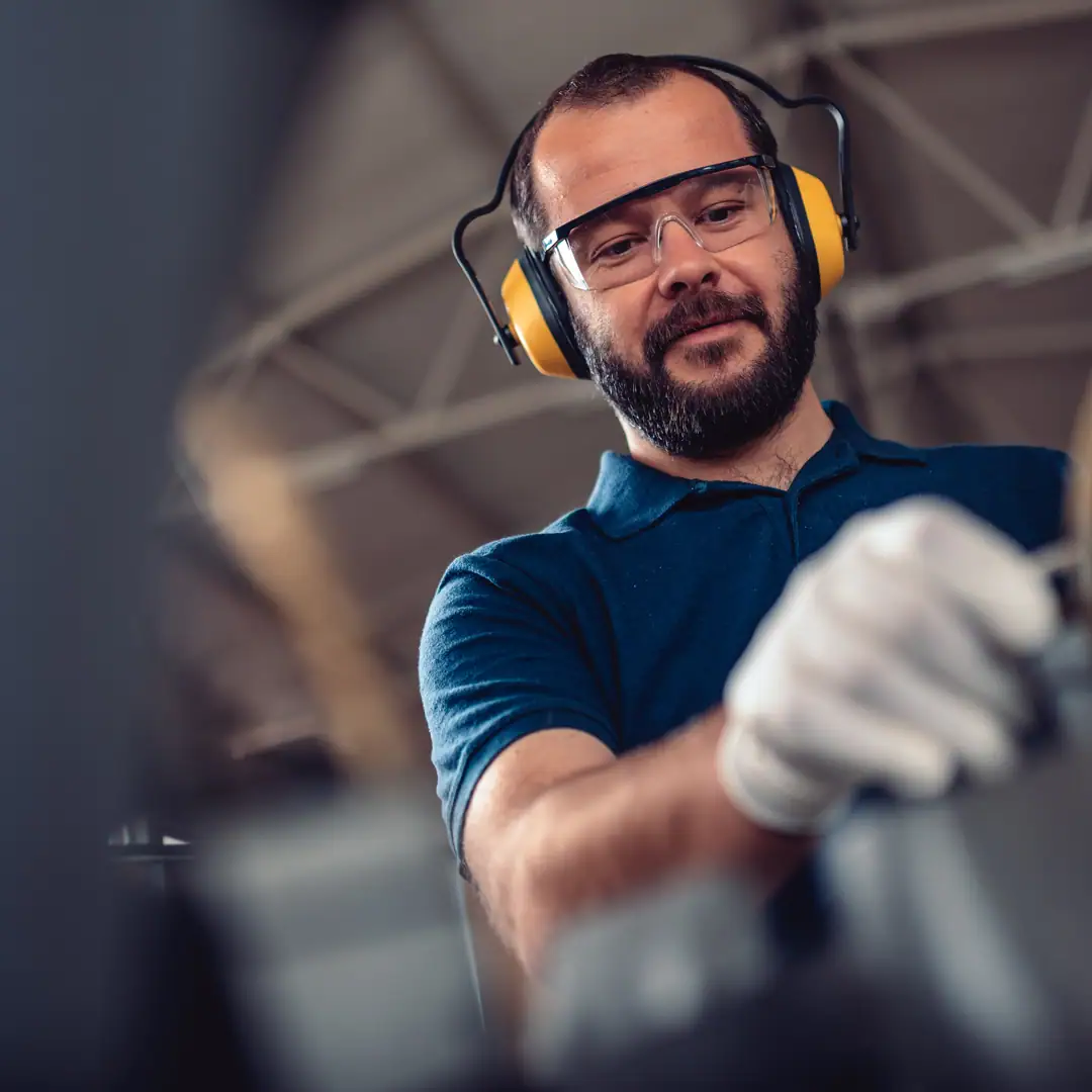 Man wearing hearing protection in a warehouse