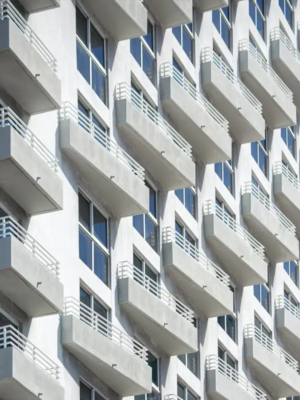 Apartment building with balconies and large windows.
