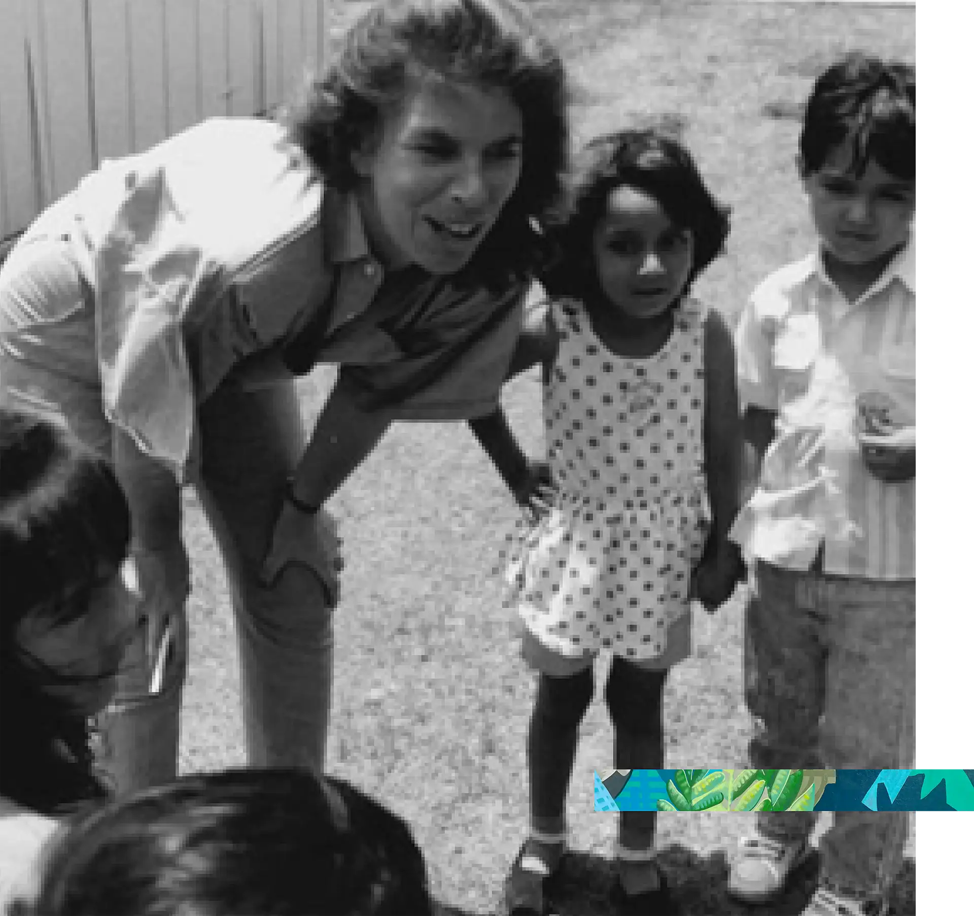 Happy group of children and adult outdoors, engaging in a fun activity.