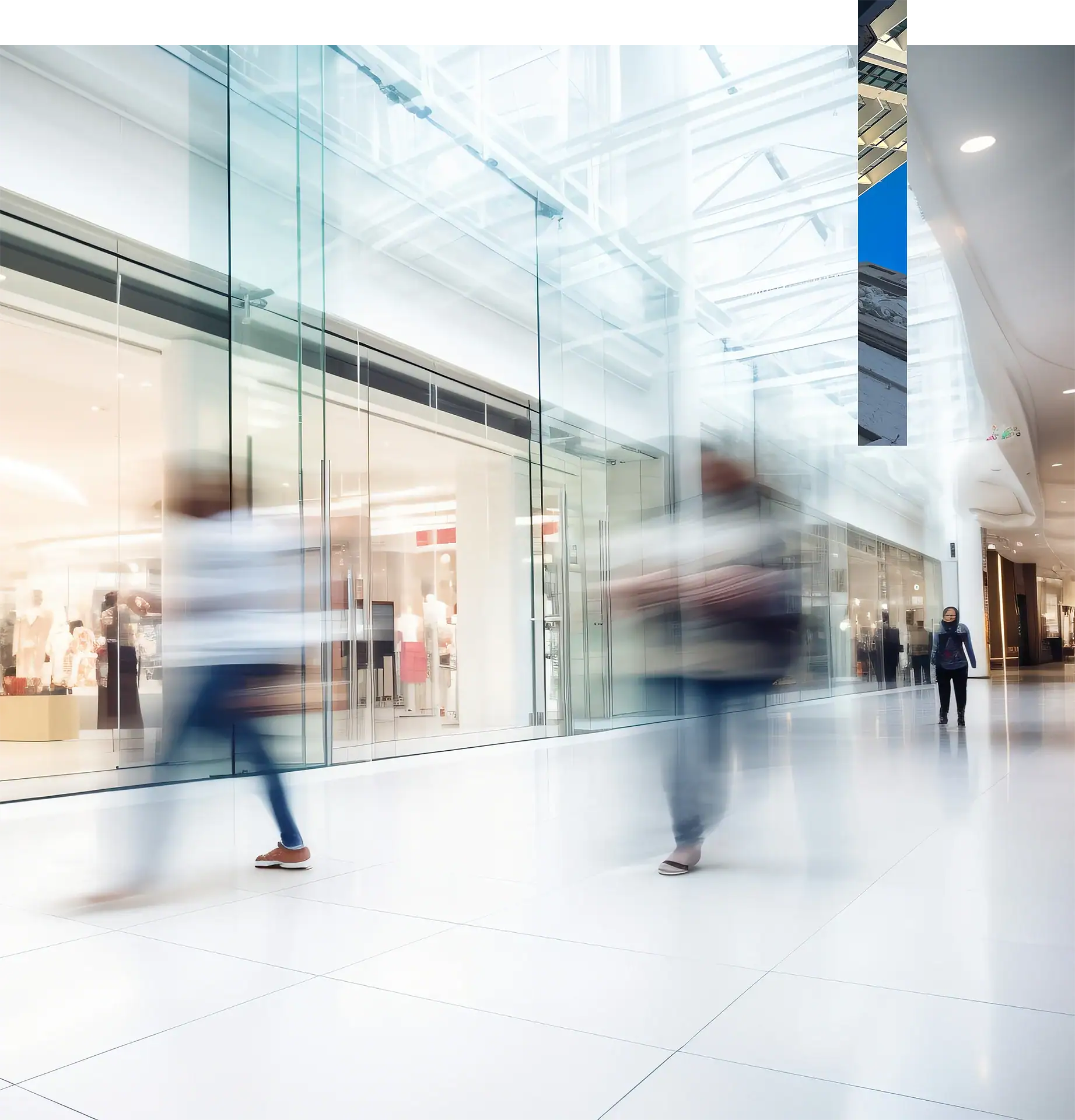 People walking through a mall at a rapid pace so they appear blurry