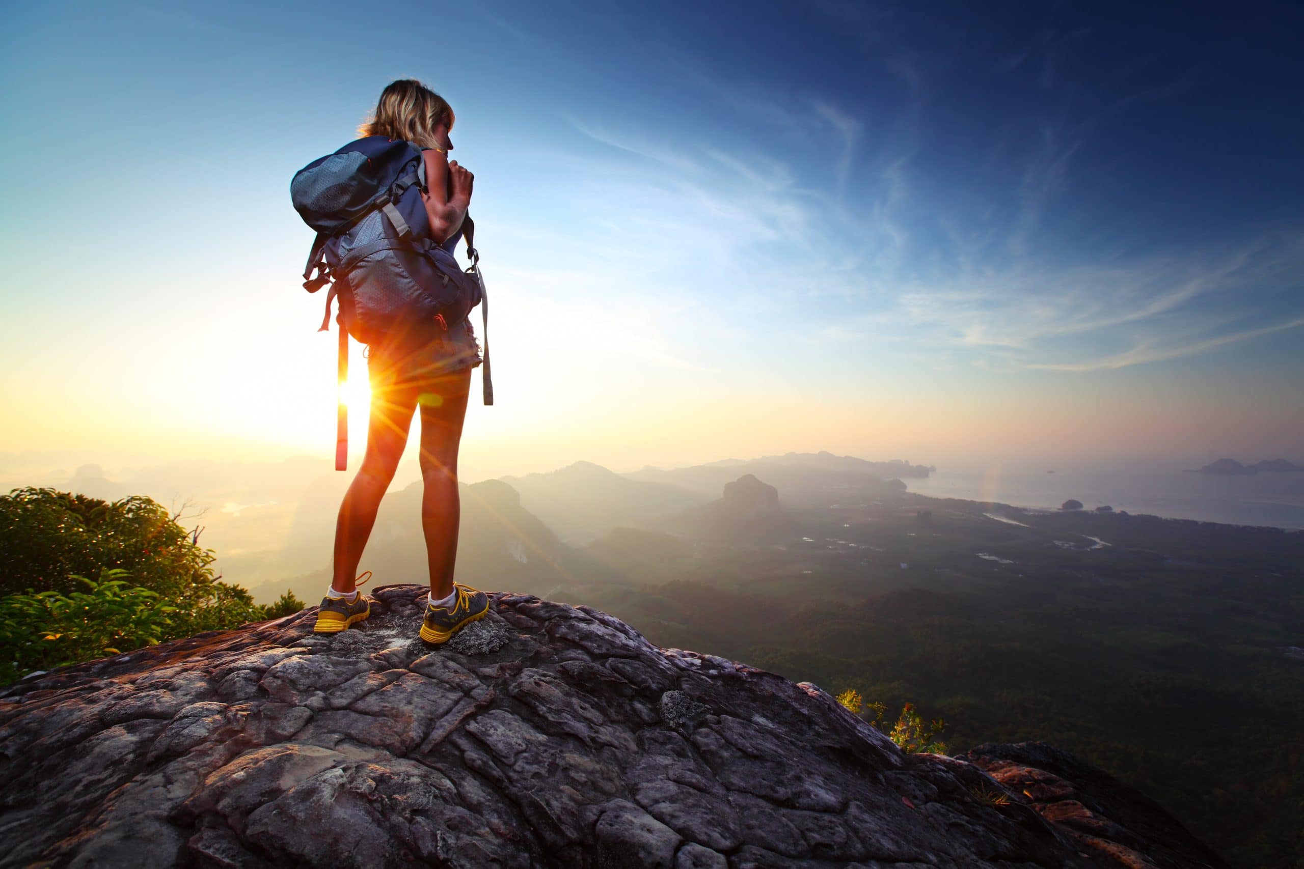 picture of a women hiking at the top of the mountain