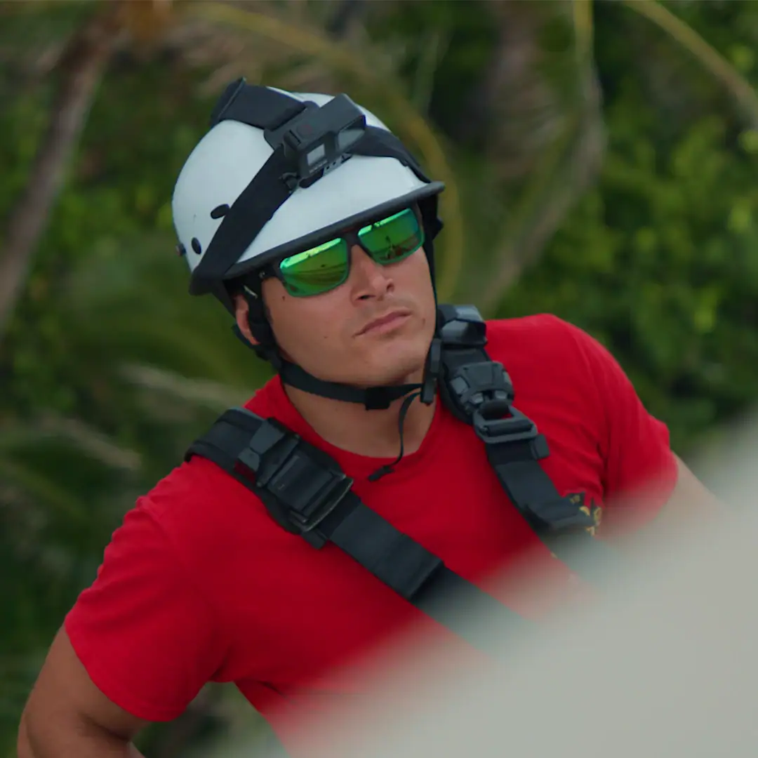 Man with Sunglasses and a Helmet Scaling a building