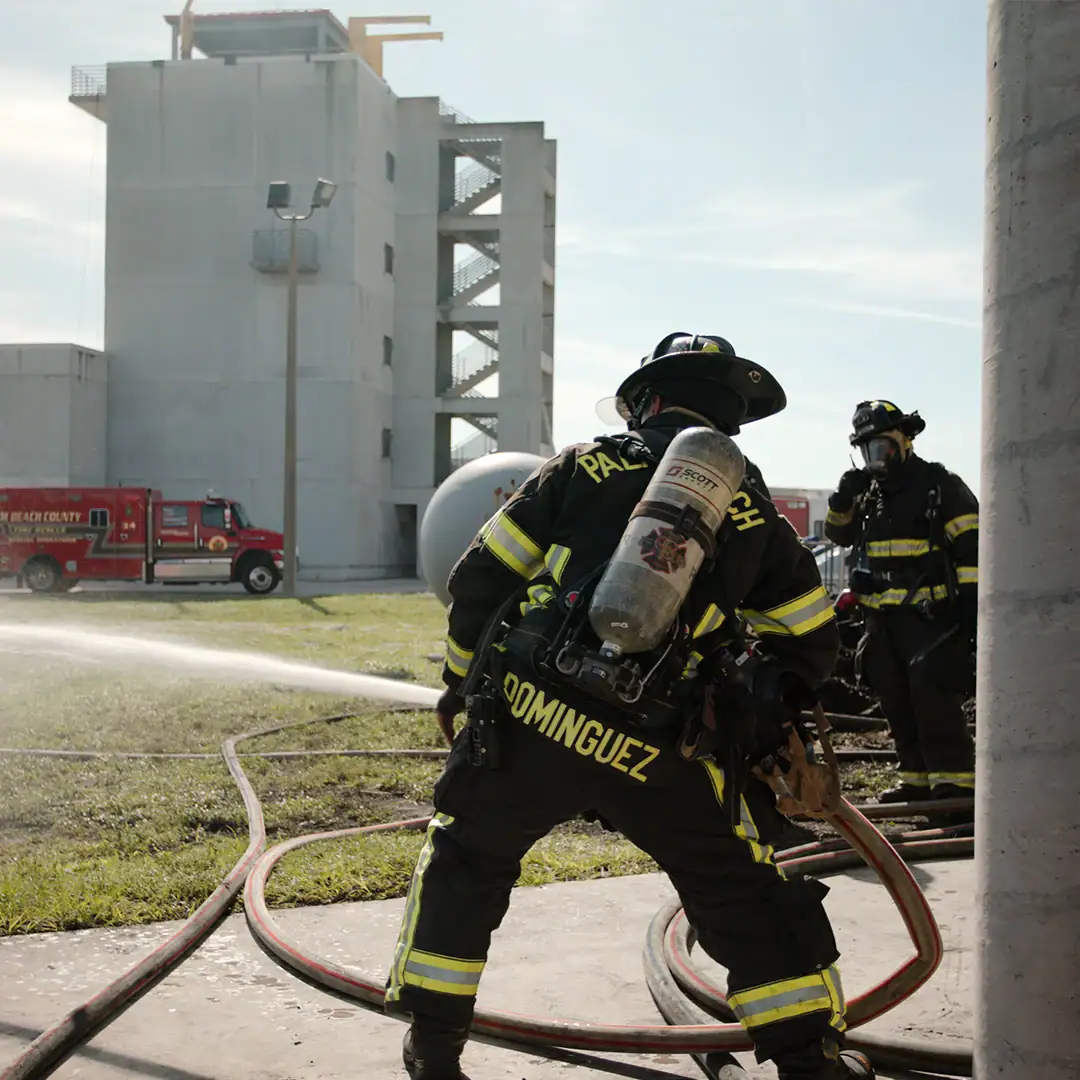 picture of a firefighter manning a hose