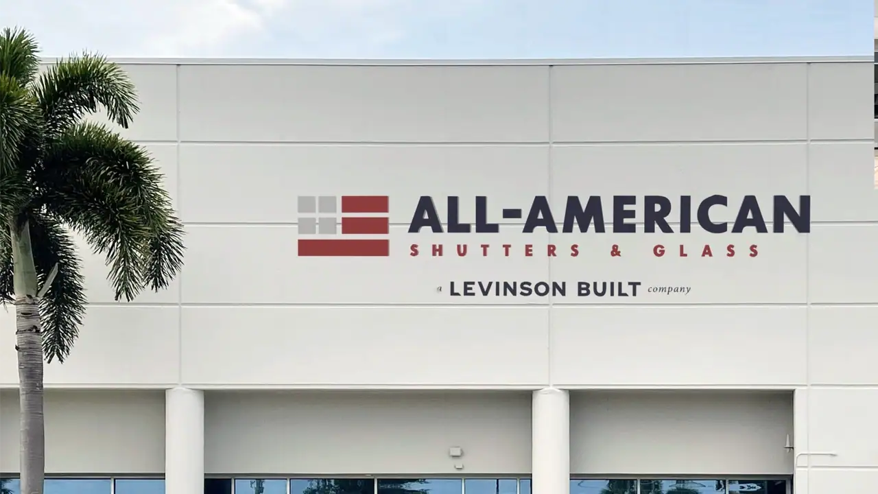 All-American Shutters & Glass Logo printed on the side of a building