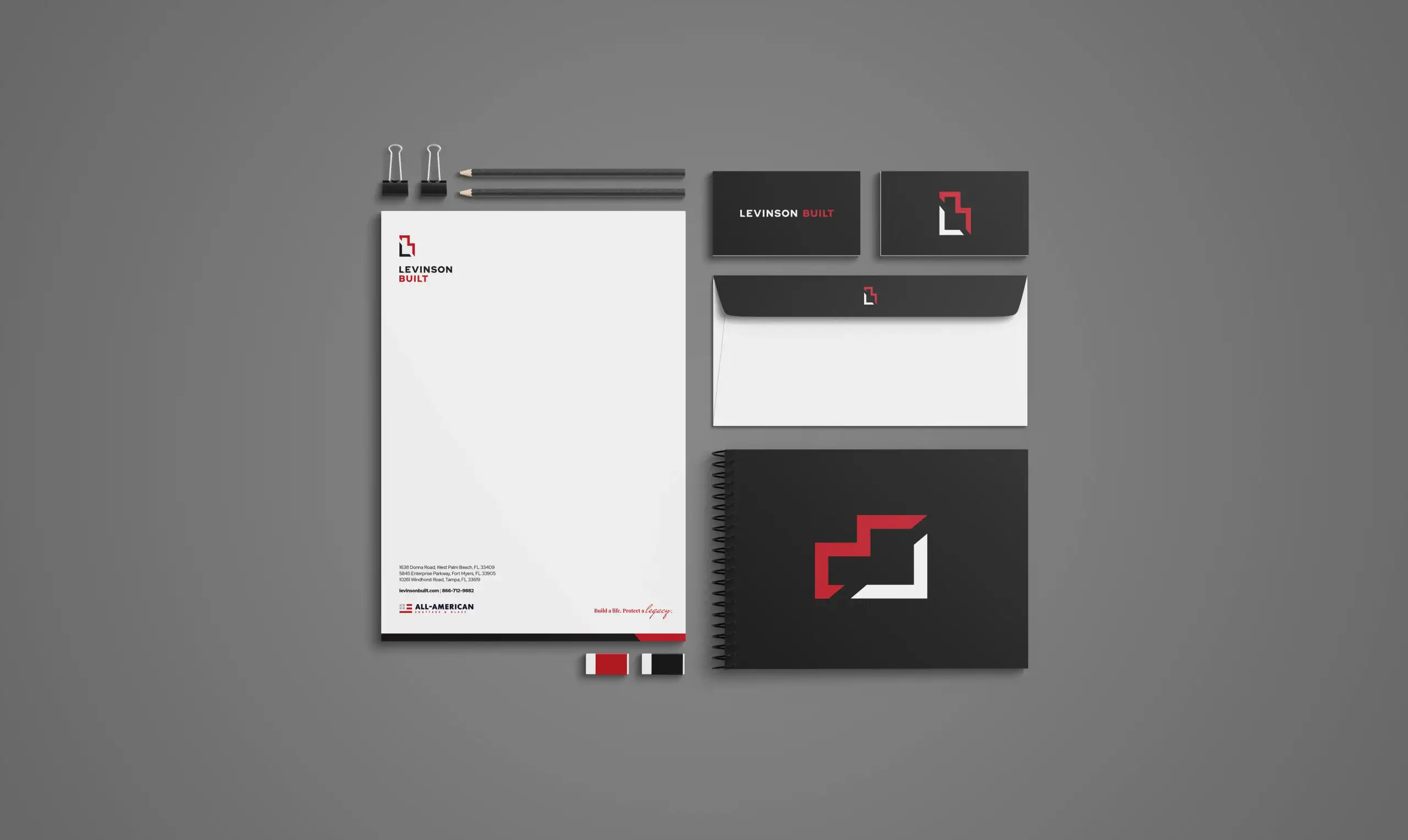 Levinson office branding materials including letterhead, business cards, and notebook.