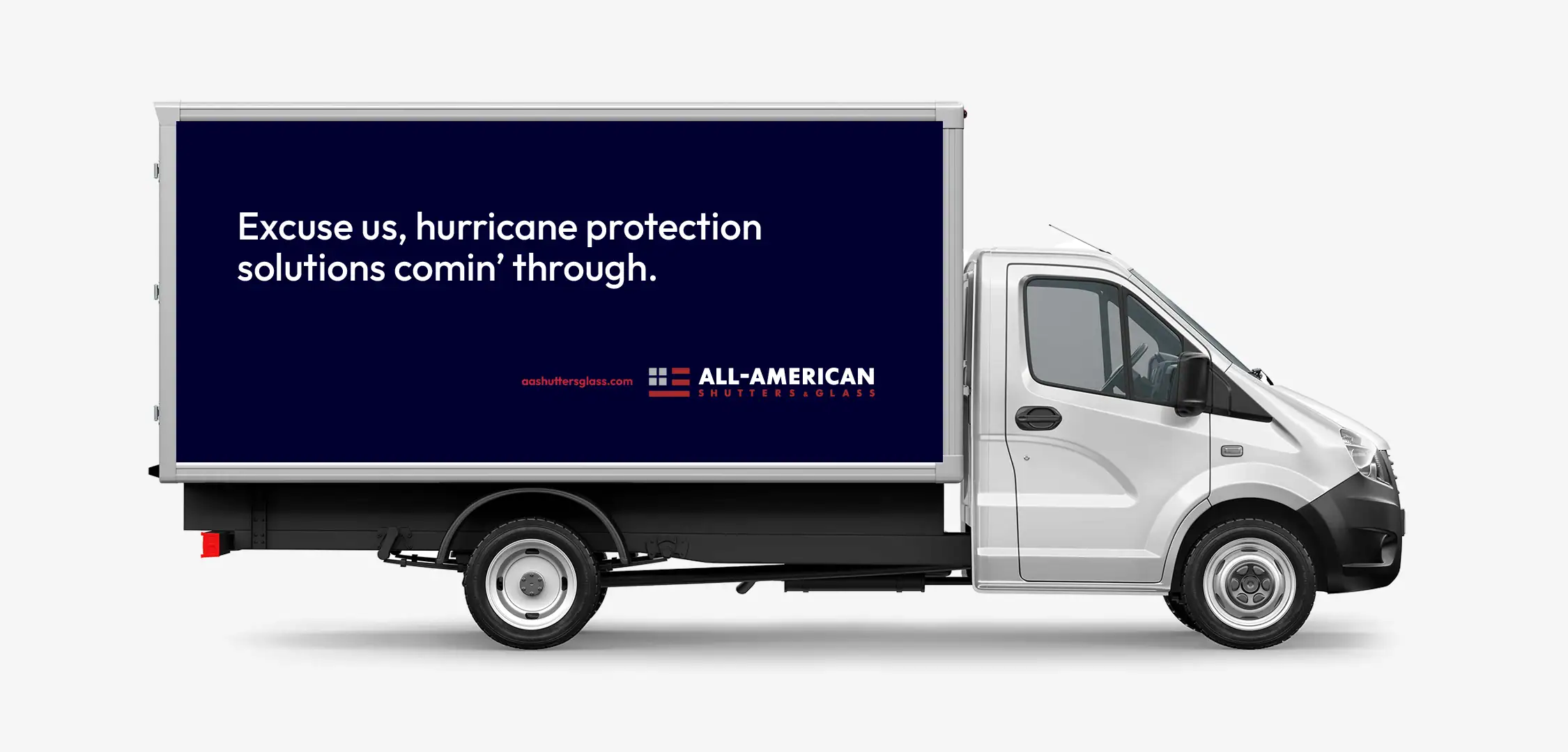 Excuse us, hurricane protection solutions comin' through. slogan on side of box truck with All American shutter glass logo