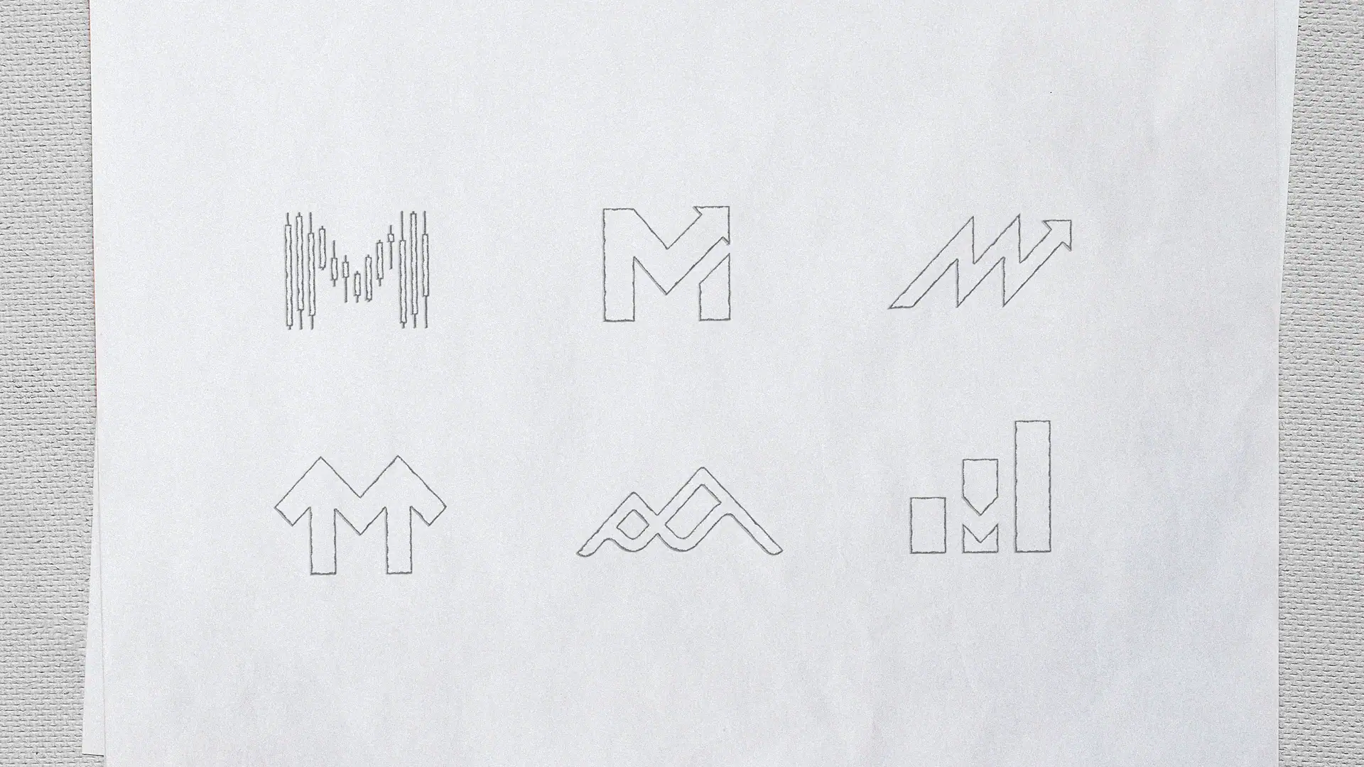 picture of multiple sketches of new logos that resemble an M